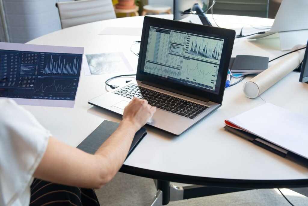 Business professional analyzing data charts on a laptop