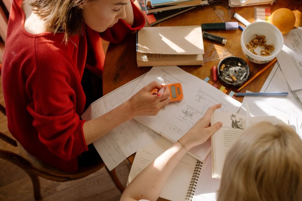 Student practicing SAT math problems with a calculator at a desk